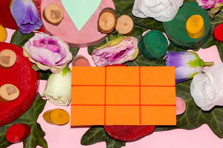 stumps of different colors and sizes and flowers with orange card divided into nine fields as copy...