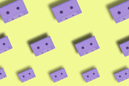 cloning purple cassettes on pastel yellow backgrounds, creative art wallpaper beautiful looksの写真素材