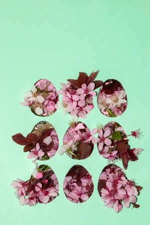 template with nine cut eggs on a pastel blue paper background, various types of flowers come out of...