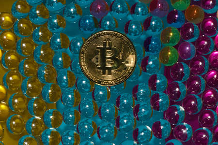 abstract futuristic background with bitcoin in the middle, vivid colors, 3d balls reflection light, modern designの写真素材