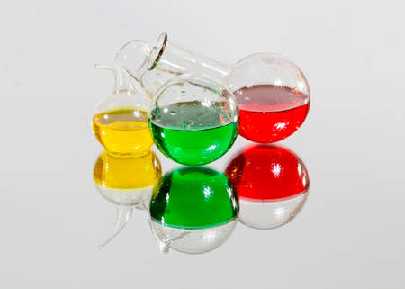 Flasks with colored liquids in chemical laboratory on glassの写真素材