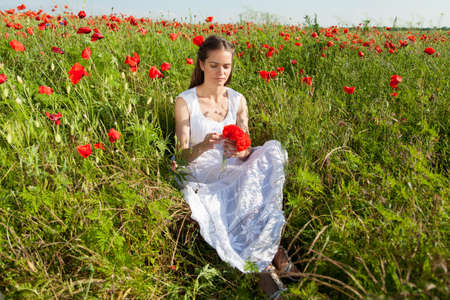 Girl in poppy fieldの写真素材