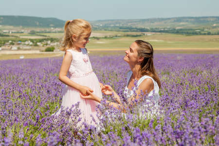 Girl with a child in a field of lavenderの写真素材