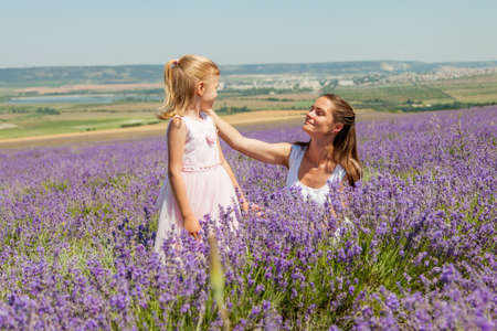 Girl with a child in a field of lavenderの写真素材