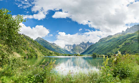 Mountain lake between mountains and trees . Turquoise water and blue sky.の写真素材