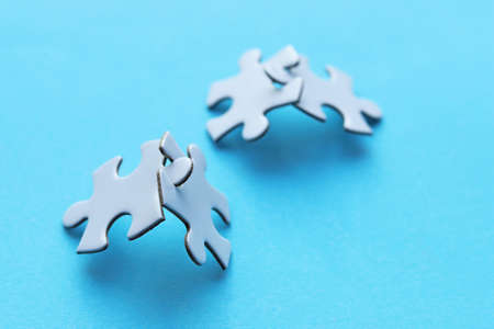 White puzzle pieces on blue background.