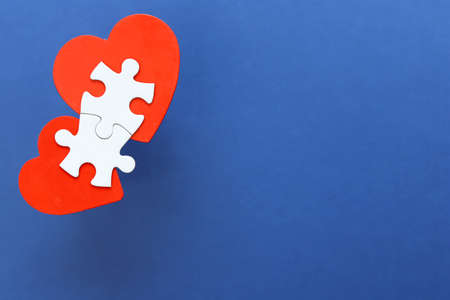 White puzzle pieces and red heart.の写真素材