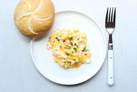 Scrabled eggs on a white plate.