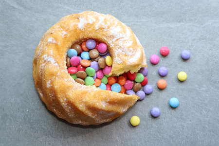 Cake with colorful candys on gray background.の写真素材