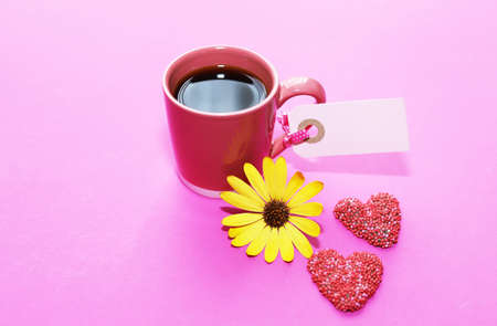Cup of coffee and red chocolate hearts.の写真素材