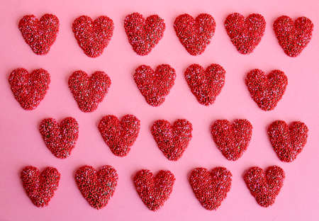 Background made of red chocolate hearts.の写真素材