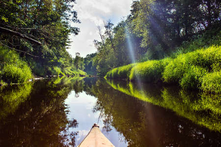 The forest river in the sun light, first-person from kayak Luchosa, Belarus.の写真素材