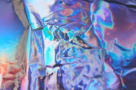 Holographic iridescent foil texture background. It can be used for posters, cards, flyers,...