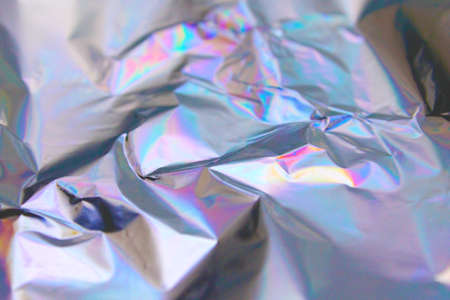 Holographic iridescent foil texture background. It can be used for posters, cards, flyers,...
