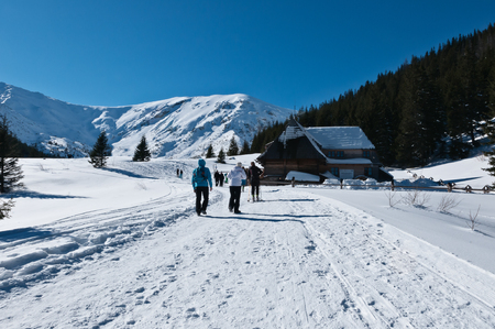 Photography in the mountains in winter. Beautiful blue sky and mountains in the snow. The road, Which roam the people. House in the snow.の写真素材