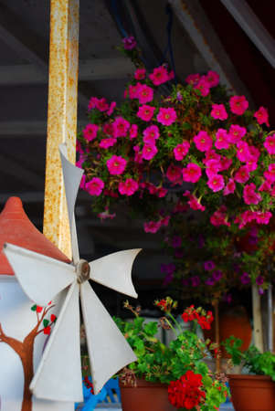 Miniature wind mill by the flowersの写真素材
