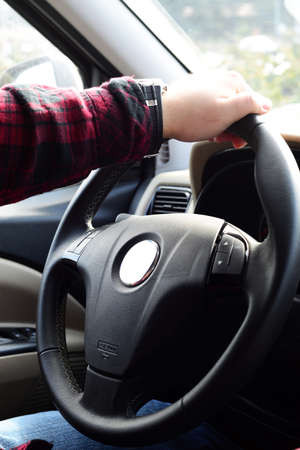 Driving car hand on steering wheelの写真素材