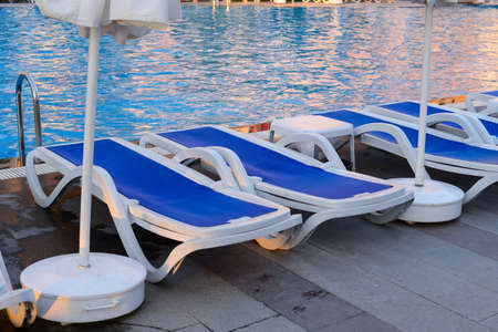 Deckchairs by swimming poolの写真素材
