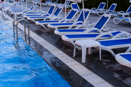Dechchairs by swimming poolの写真素材