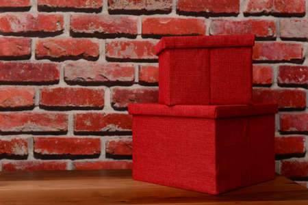 Red canvas boxes by the brick textured wallpaperの写真素材