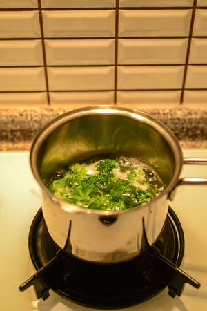 Broccoli boiling in frypanの写真素材