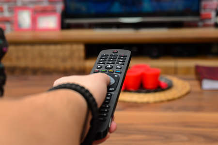 Remote controller in hand zappingの写真素材
