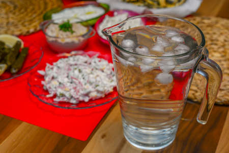 Water with ice cubes in carafeの写真素材