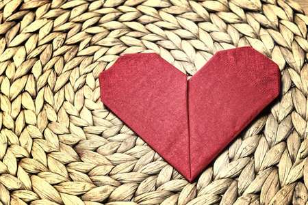 Heart shape napkin on rush matの写真素材