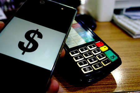 Making payment with mobile phoneの写真素材