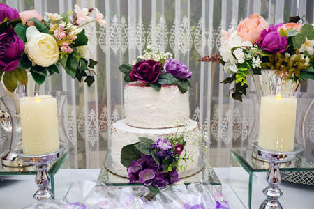 Engagement catering concept with ornaments candles cake and chocolateの写真素材