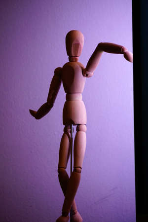 Wooden sketch model under the purple light close up view vertical imageの写真素材