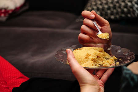 Eating Semolina helva dessert eating close up view in the glass dishの写真素材