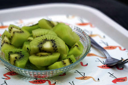 Sliced kiwi fruit on glass bowl close up viewの写真素材