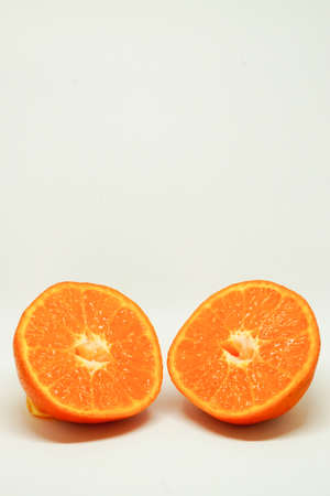 Peeled orange and mandarin slices on white isolated backgroundの写真素材