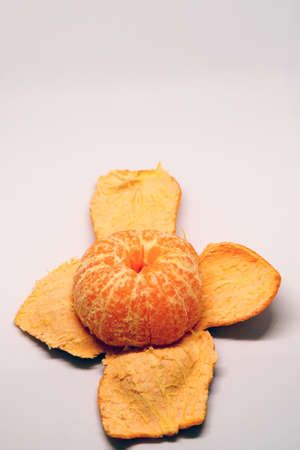 Peeled orange and mandarin slices on white isolated backgroundの写真素材