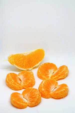 Peeled orange and mandarin slices on white isolated backgroundの写真素材