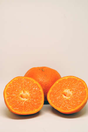 Peeled orange and mandarin slices on white isolated backgroundの写真素材