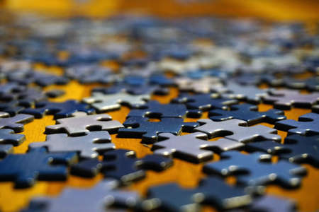 Making puzzle at home on wooden background bokeh effect close up viewの写真素材