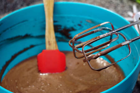 Preparing brownie cake at home with mixer whisk and oven processesの写真素材