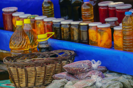 Farmers market in Bursa Turkey selling homemade pickles olive oil herbs close up view