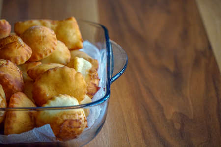 Leavened dough pastry on glass dish on wooden background with copyspace Turkish breakfast conceptの写真素材