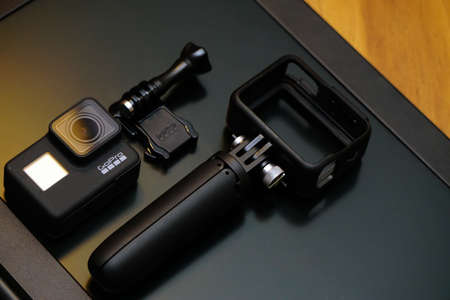 16 May 2019 Eskisehir, Turkey. Gopro 7 black assorted accessories and laptop on wooden backgroundのeditorial素材