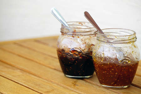 Fig and orange jam jar on wooden backgroundの写真素材
