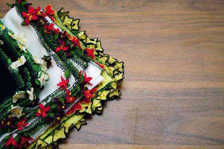 Handmade embroidery head scarf on wooden backgroundの写真素材