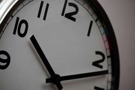 Wall clock with white base and black dials close up viewの写真素材