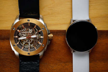 Analog and smart watches on wooden background with copyspaceの写真素材