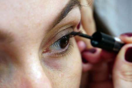 Woman making eye make up close up viewの写真素材