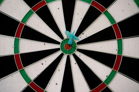 Dart game with the arrow on the center target close up viewの写真素材