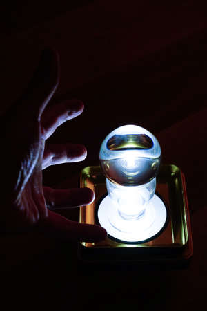 Glass sphere fortune telling with man hand