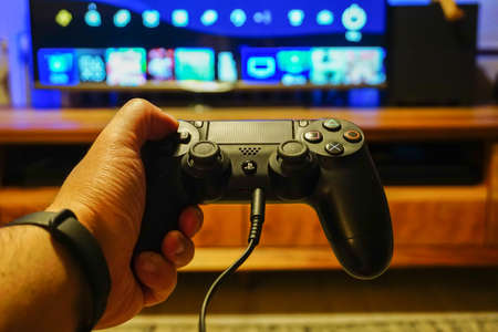 5 December 2019, Eskisehir Turkey. Ps4 gamepad in gamer man handのeditorial素材